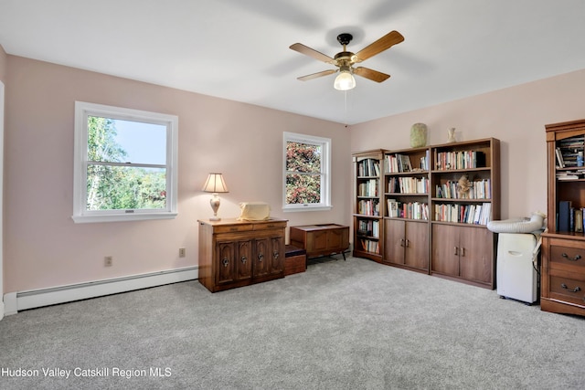 living area with light carpet, a baseboard radiator, and ceiling fan