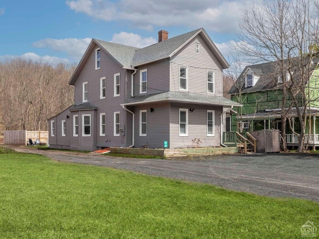 7614 Main St, Hunter, NY 12444 - view of front of home with a chimney, a front yard, and roof with shingles