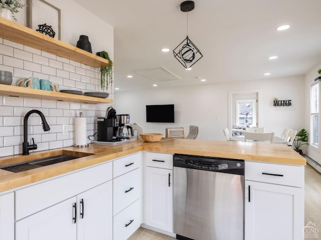 7614 Main St, Hunter, NY 12444 - kitchen with dishwasher, a sink, open shelves, butcher block countertops, and decorative backsplash