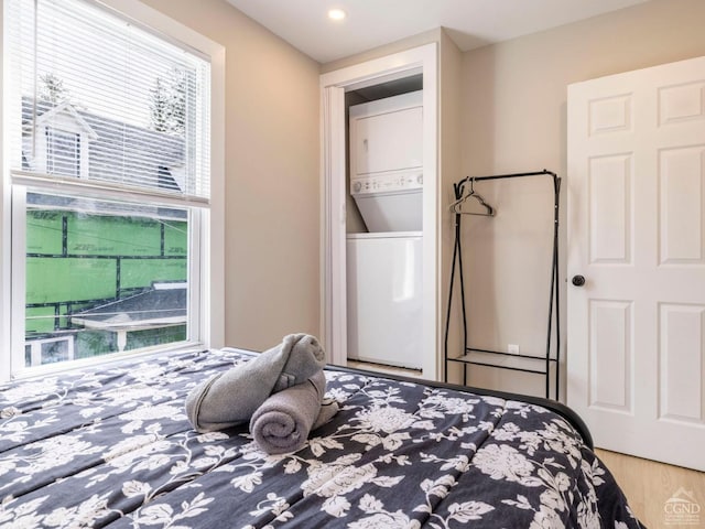 7614 Main St, Hunter, NY 12444 - bedroom featuring stacked washer / dryer, wood finished floors, and recessed lighting