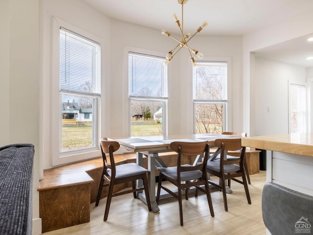 7614 Main St, Hunter, NY 12444 - dining room with a chandelier, healthy amount of natural light, and light wood-type flooring