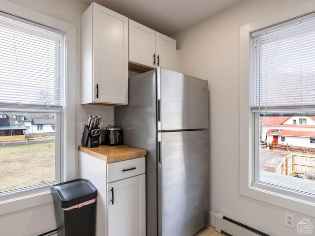 7614 Main St, Hunter, NY 12444 - kitchen featuring healthy amount of natural light, baseboard heating, and white cabinets