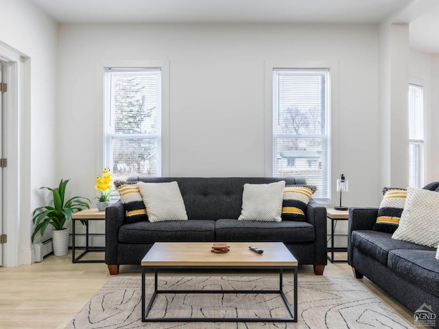7614 Main St, Hunter, NY 12444 - living area with healthy amount of natural light, light wood-style flooring, and baseboard heating