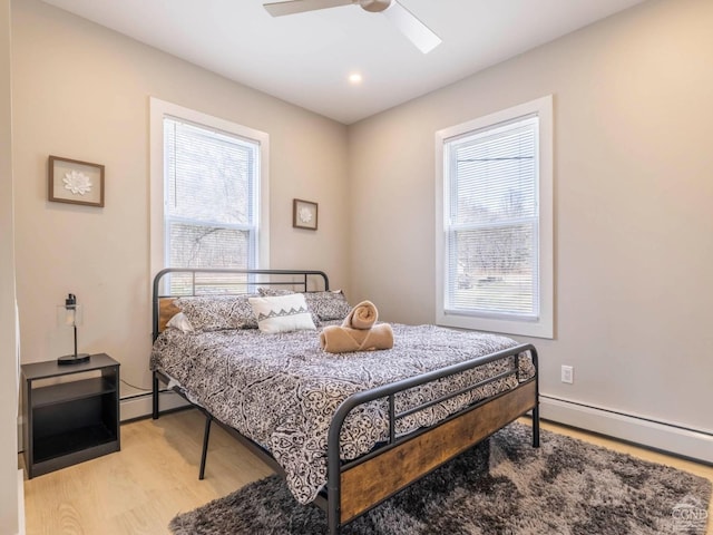 7614 Main St, Hunter, NY 12444 - bedroom featuring a baseboard heating unit, light wood-style flooring, ceiling fan, and recessed lighting