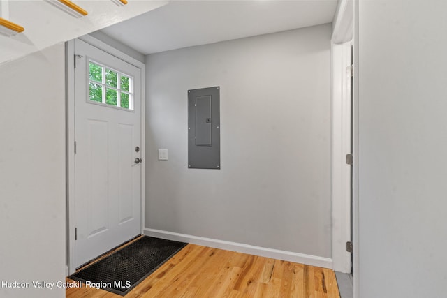 entryway featuring electric panel, wood finished floors, and baseboards