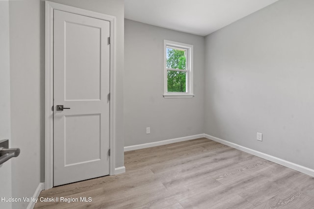 unfurnished room featuring wood finished floors and baseboards