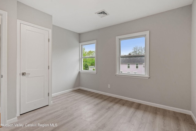 unfurnished bedroom featuring light wood-style flooring and baseboards