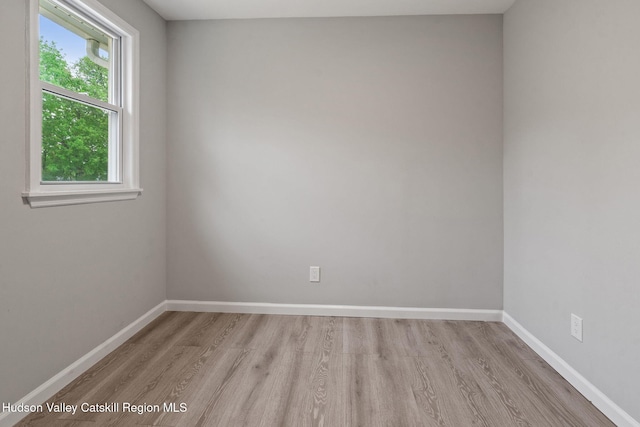 unfurnished room featuring light wood-type flooring and baseboards
