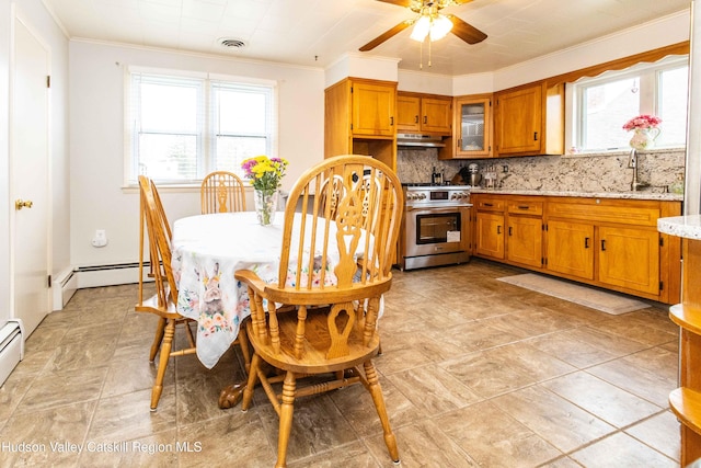 kitchen featuring brown cabinetry, ornamental molding, baseboard heating, under cabinet range hood, and stainless steel range