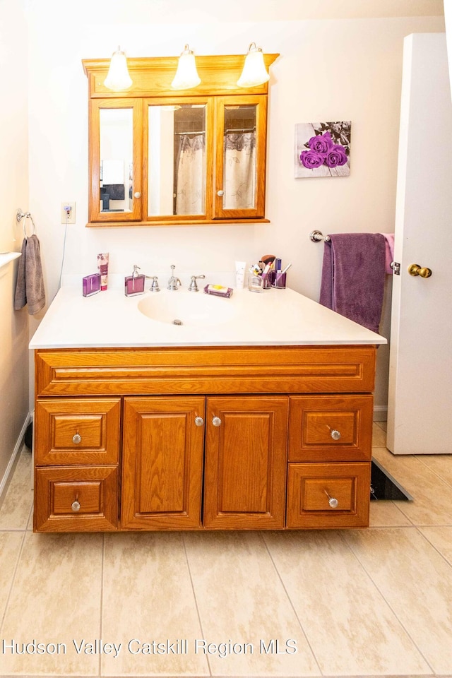 full bath with tile patterned floors and vanity