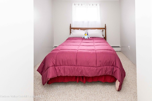 bedroom featuring a baseboard heating unit and carpet