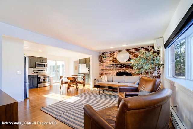 living room with a baseboard radiator, brick wall, light hardwood / wood-style flooring, and an AC wall unit