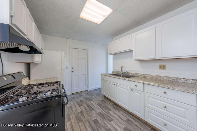 9 Hasbrouck Pl, Kingston, NY 12401 - kitchen with black gas range oven, a sink, white cabinets, range hood, and a paneled ceiling