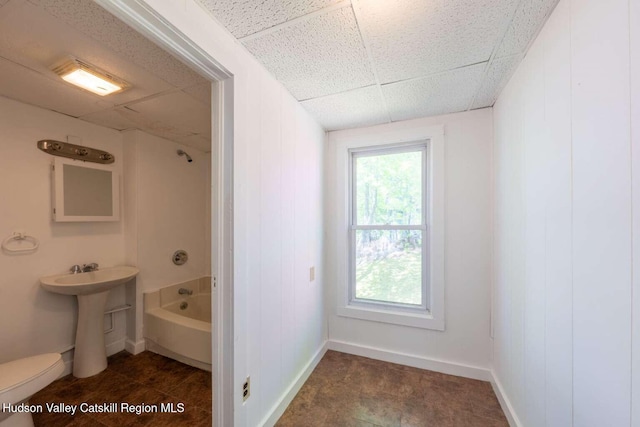 9 Hasbrouck Pl, Kingston, NY 12401 - bathroom featuring a paneled ceiling, tub / shower combination, toilet, a sink, and baseboards
