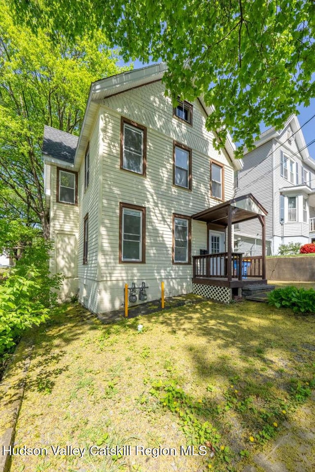 9 Hasbrouck Pl, Kingston, NY 12401 - rear view of property featuring a deck and a yard