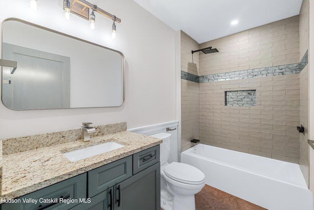 full bathroom featuring vanity, toilet, and tiled shower / bath