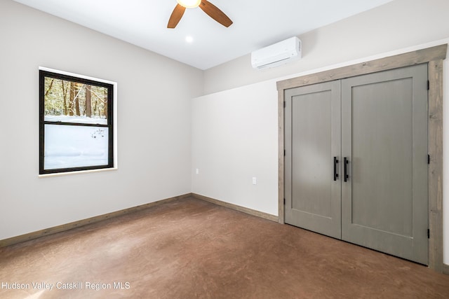 unfurnished bedroom featuring an AC wall unit, a closet, and ceiling fan