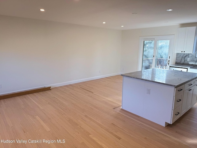 16 Trinity Pl, Rhinebeck, NY 12572 - kitchen with white cabinetry, light wood-style flooring, a center island, and recessed lighting