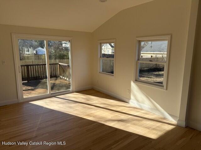 16 Trinity Pl, Rhinebeck, NY 12572 - spare room featuring wood finished floors, baseboards, and lofted ceiling