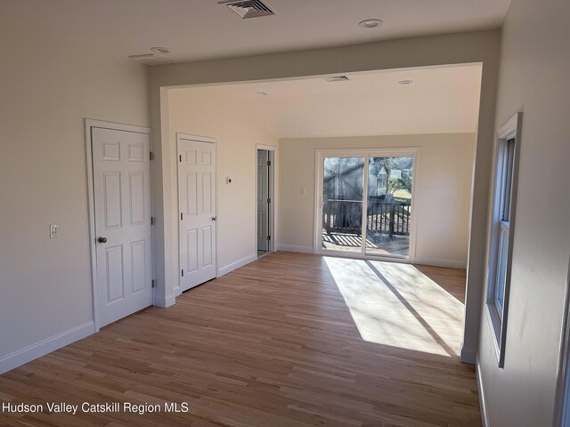 16 Trinity Pl, Rhinebeck, NY 12572 - corridor with wood finished floors, baseboards, and vaulted ceiling
