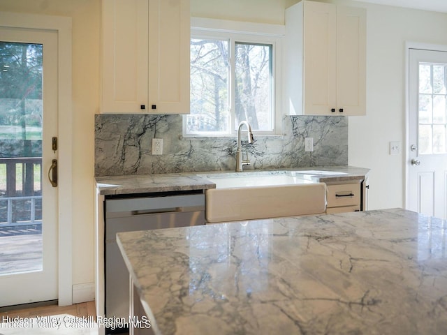 16 Trinity Pl, Rhinebeck, NY 12572 - kitchen featuring dishwasher, a sink, light stone countertops, backsplash, and white cabinets