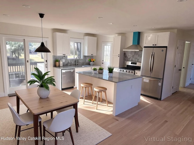 16 Trinity Pl, Rhinebeck, NY 12572 - kitchen with appliances with stainless steel finishes, wall chimney range hood, a sink, tasteful backsplash, and recessed lighting