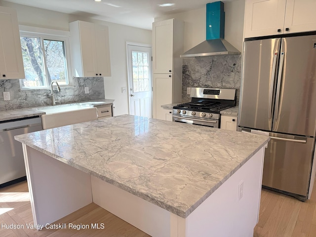16 Trinity Pl, Rhinebeck, NY 12572 - kitchen with stainless steel appliances, wall chimney exhaust hood, light stone countertops, and decorative backsplash