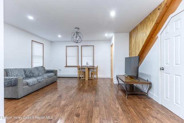 living room featuring dark wood-type flooring and a notable chandelier