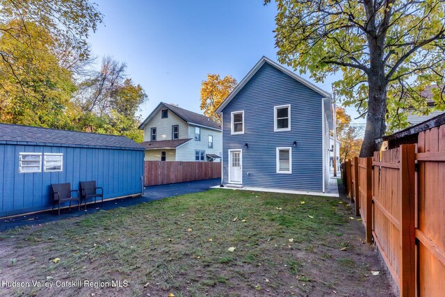 rear view of property featuring a yard