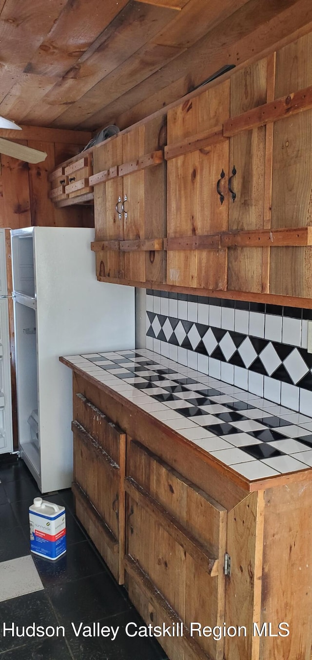 kitchen featuring tasteful backsplash, tile counters, and wood ceiling