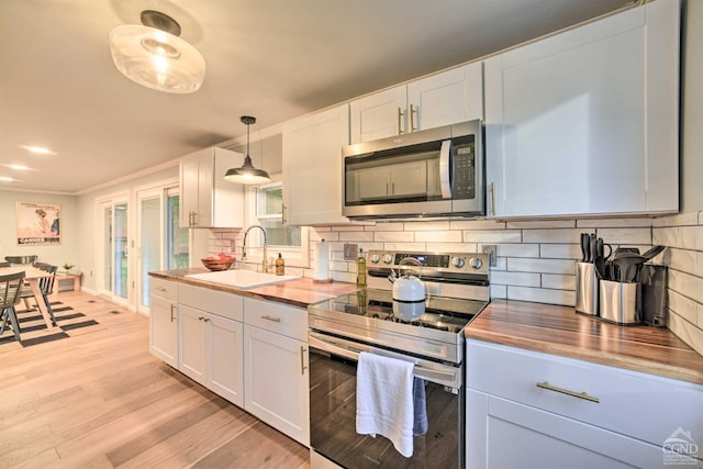 871 Mail Route Rd, Ashland, NY 12407 - kitchen featuring stainless steel appliances, a sink, wooden counters, light wood-style flooring, and tasteful backsplash