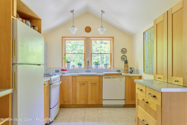 kitchen featuring sink, light brown cabinets, hanging light fixtures, vaulted ceiling, and white appliances