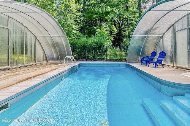 view of pool with an outdoor structure