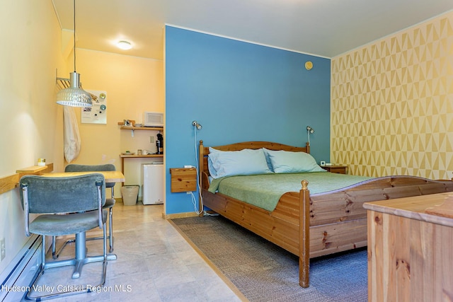 bedroom with tile walls and a baseboard heating unit