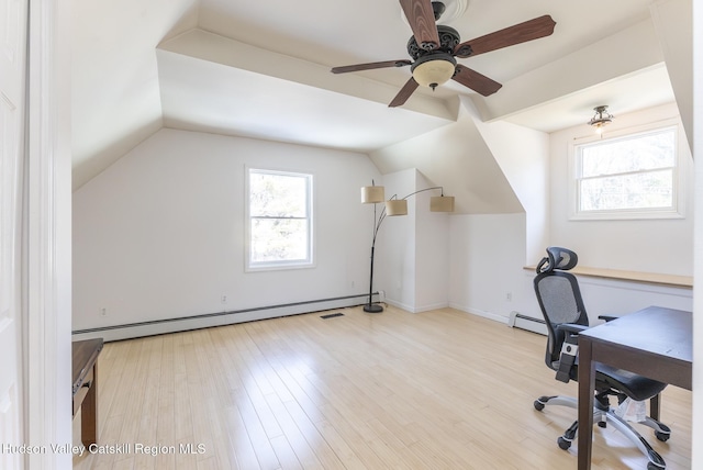 unfurnished office with lofted ceiling, baseboard heating, wood finished floors, and a ceiling fan