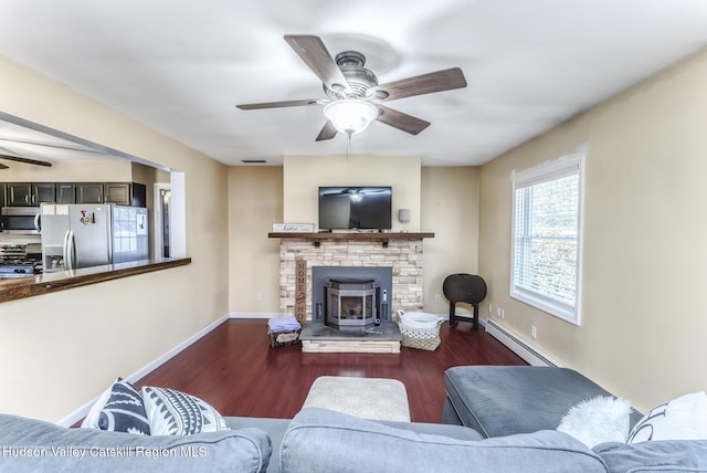 living room with ceiling fan, baseboard heating, wood finished floors, and baseboards