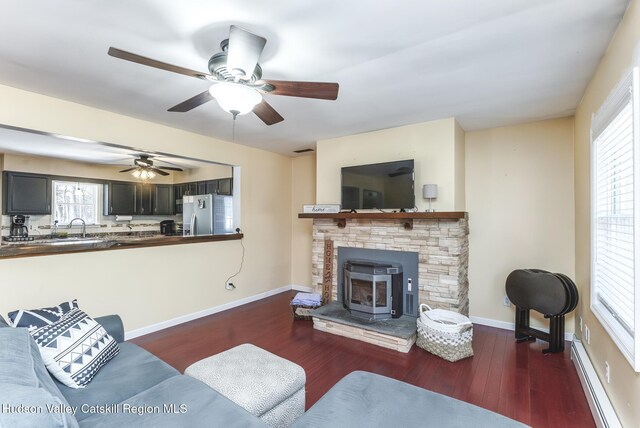 dining space with hardwood / wood-style floors, sink, a wealth of natural light, and ceiling fan