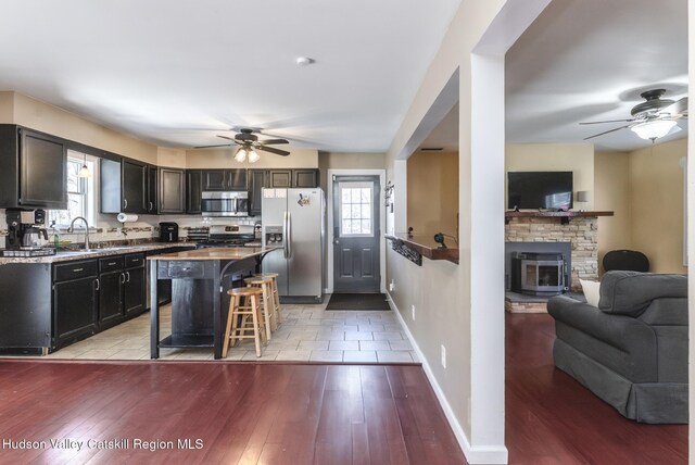 office area featuring hardwood / wood-style flooring, a baseboard radiator, and ceiling fan