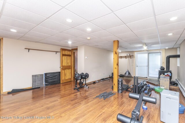 bedroom with ceiling fan, a closet, dark wood-type flooring, and a baseboard radiator