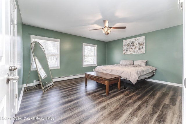 bedroom featuring baseboards, a baseboard heating unit, ceiling fan, and wood finished floors