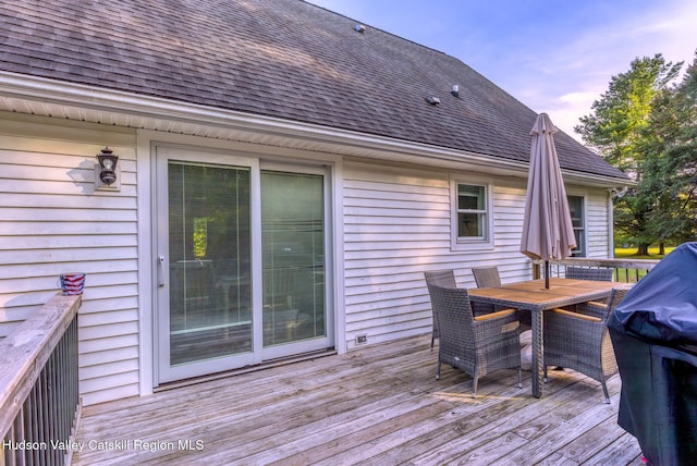 deck with area for grilling and outdoor dining space