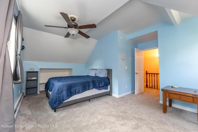 bedroom with light colored carpet, vaulted ceiling, baseboard heating, and ceiling fan