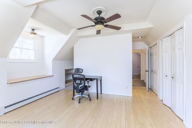 office area with a baseboard heating unit, wood finished floors, a ceiling fan, and lofted ceiling