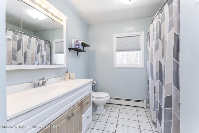 bathroom with toilet, baseboard heating, vanity, and tile patterned floors