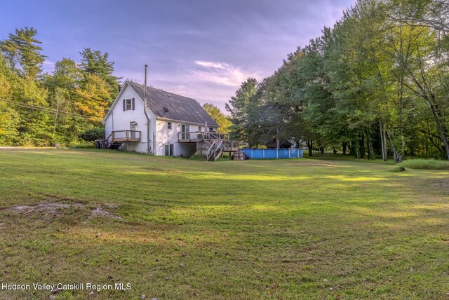 view of yard with a swimming pool side deck