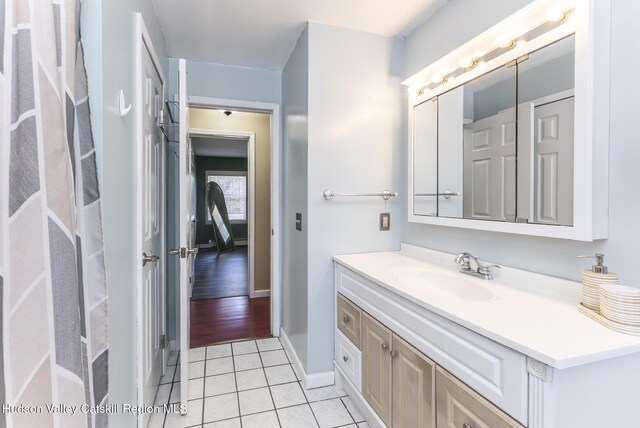 bathroom featuring baseboards, vanity, and tile patterned floors