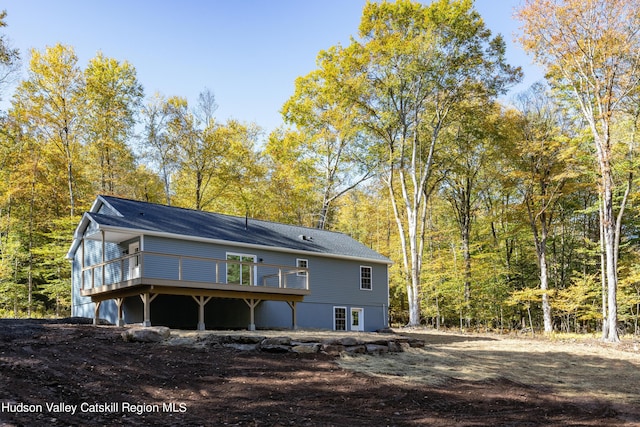 rear view of property with a wooden deck