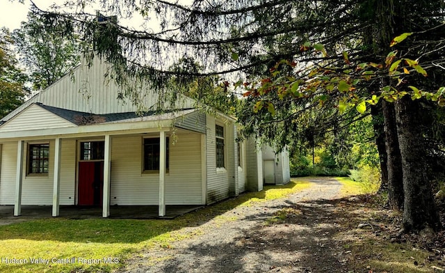71 Watson Hollow Rd, West Shokan, NY 12494 - view of front facade with a shingled roof, dirt driveway, and covered porch