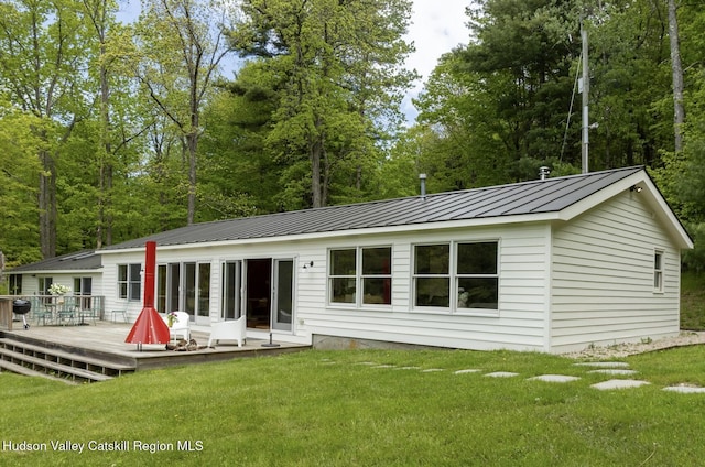 35 Jilroy Ln, Spencertown, NY 12165 - back of house with a wooden deck, a lawn, a standing seam roof, and a metal roof