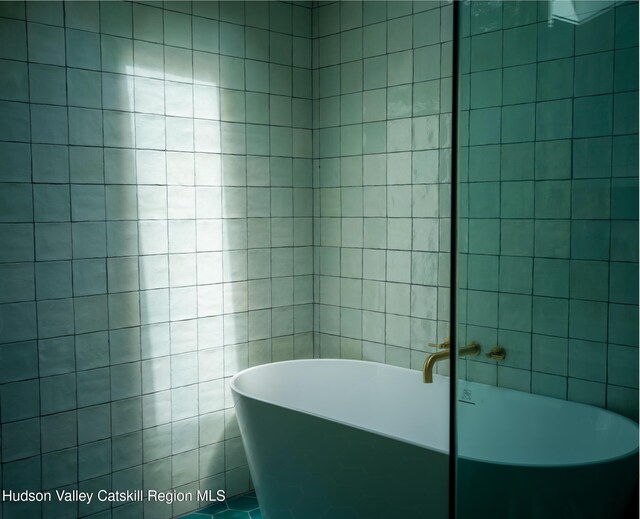 35 Jilroy Ln, Spencertown, NY 12165 - bathroom with a soaking tub and tile walls
